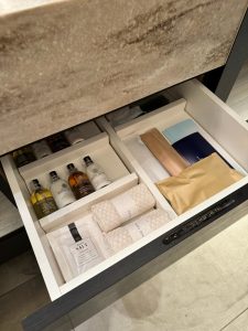 Bathroom drawer with Molten Brown toiletries, combs, brushes, and luxury amenities at Hotel Allamanda Aoyama