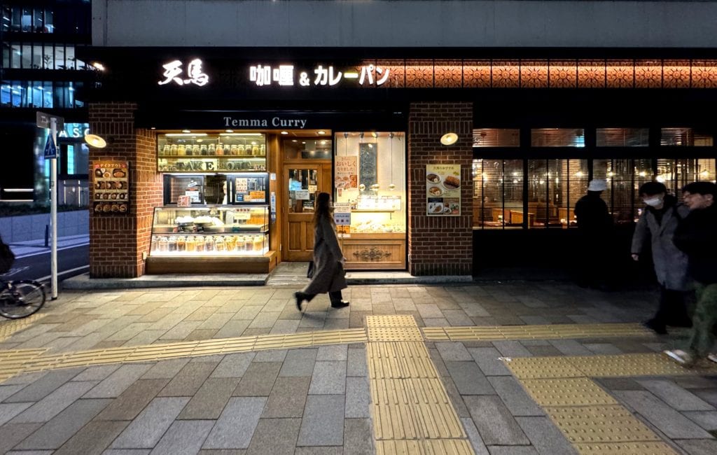 Street view of Temma Curry restaurant in Minamiaoyama, Tokyo at night with warm lighting