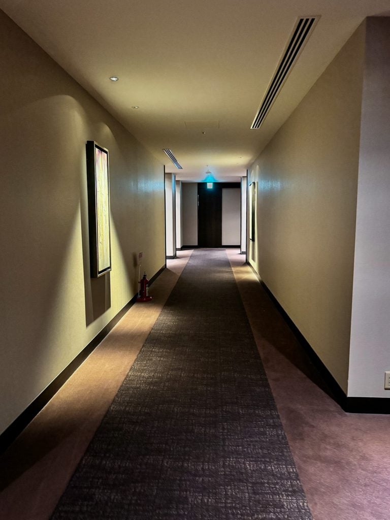 Hotel Allamanda Aoyama Tokyo hallway with soft lighting and dark wood accents