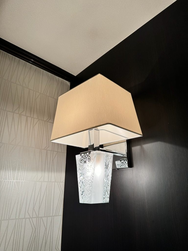 Close-up of reading lamp and textured wall at Hotel Allamanda