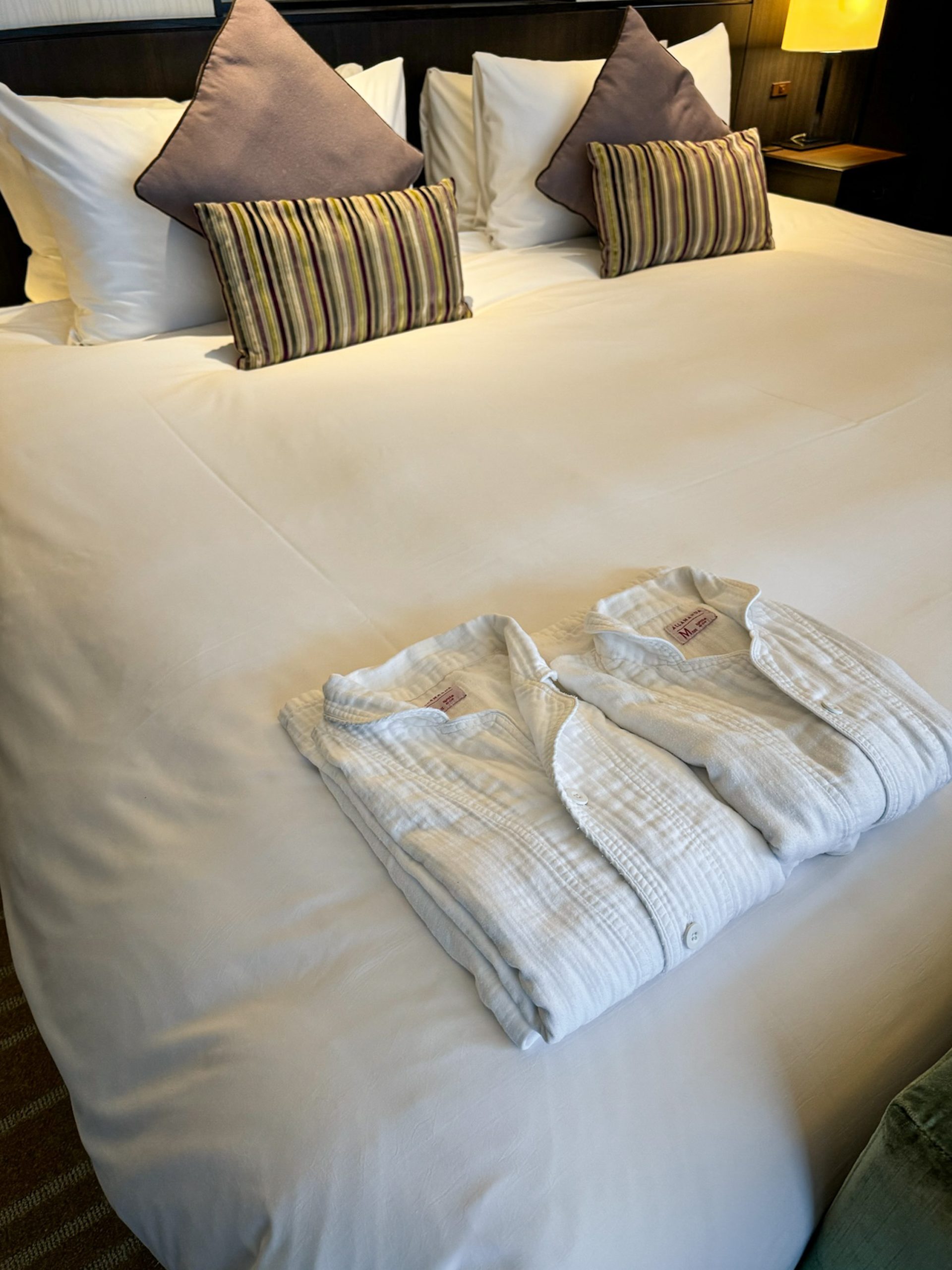 Two white robes neatly folded on the bed inside a Superior Double Room at Hotel Allamanda Aoyama Tokyo.