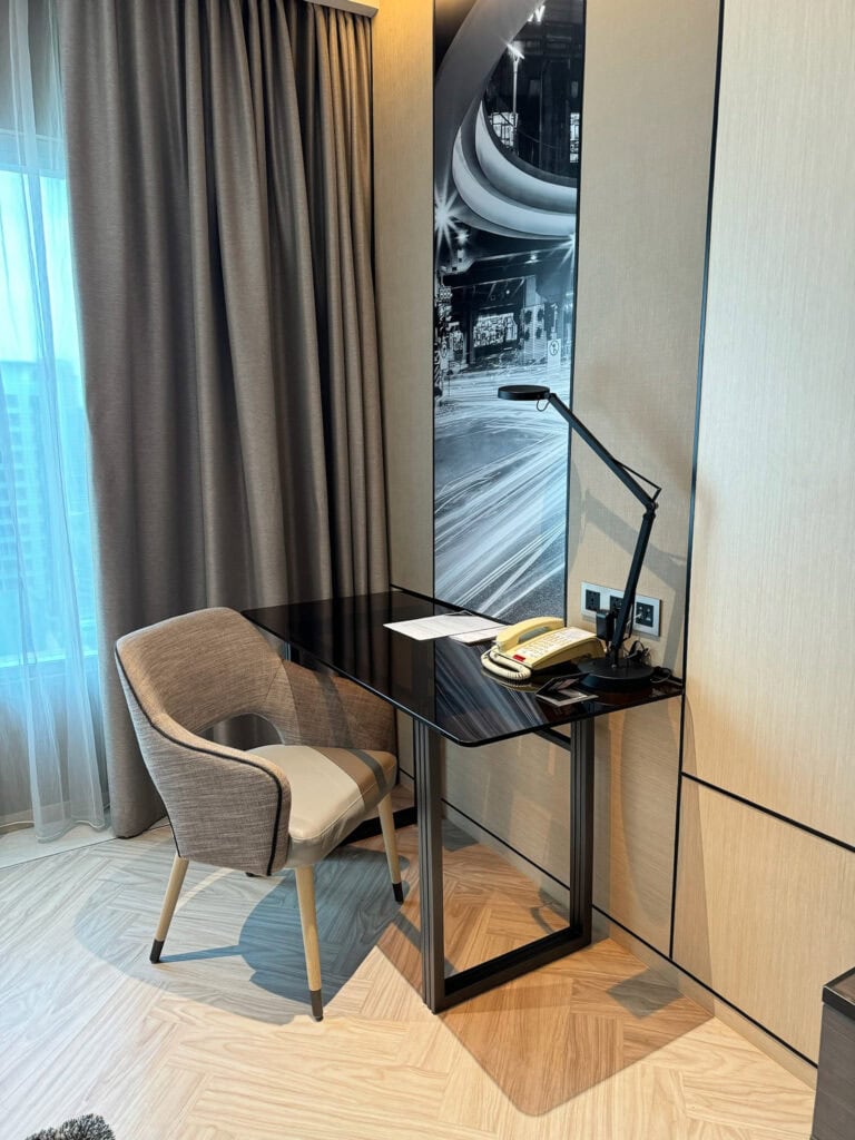 Desk area at Pathumwan Princess Hotel with Pathumwan Skywalk wall motif