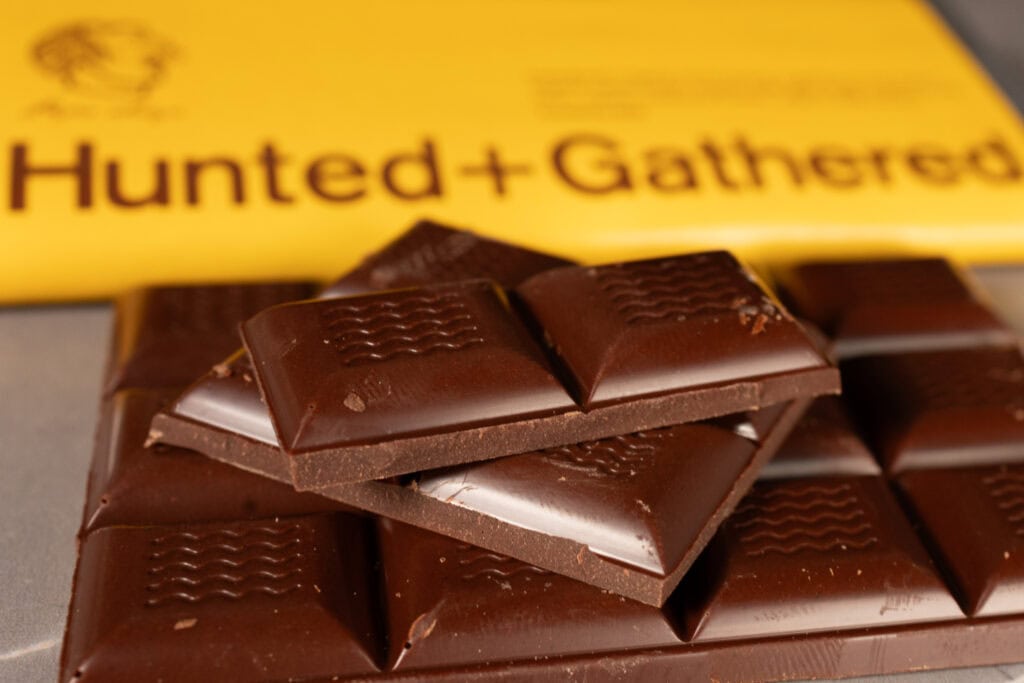 Close-up of Hunted + Gathered Milk Chocolate + Brown Butter 55% Cacao bar with stacked squares