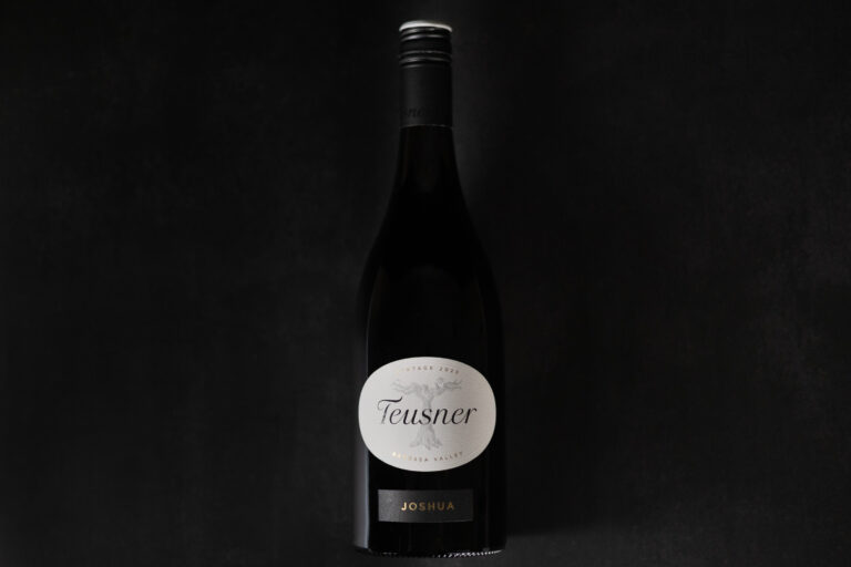 Teusner Joshua 2023 GSM wine bottle photographed against a dark background