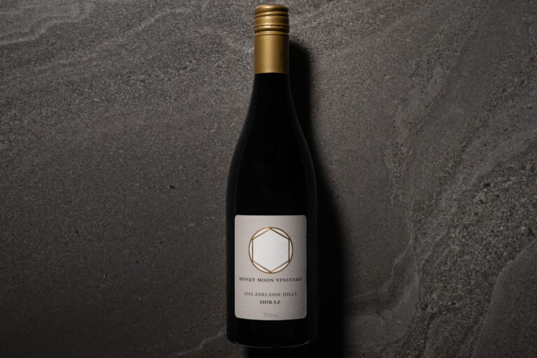 Honeymoon Vineyard Shiraz 2014 bottle photographed on a dark stone surface with soft side lighting.