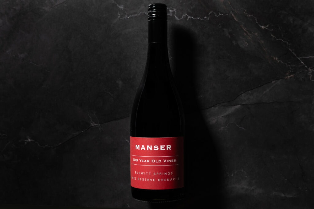 Manser 100 Year Old Vines Reserve Grenache 2022 bottle on dark stone background
