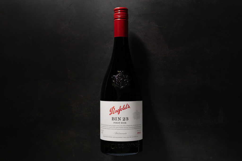 Penfolds Bin 23 Pinot Noir 2021 bottle on a dark stone background