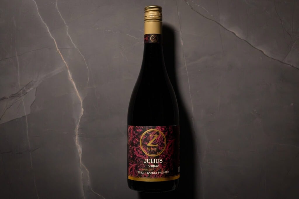 Z WINE Julius Shiraz 2022 bottle on dark marble surface – elegant lighting highlighting the gold screwcap and intricate maroon label