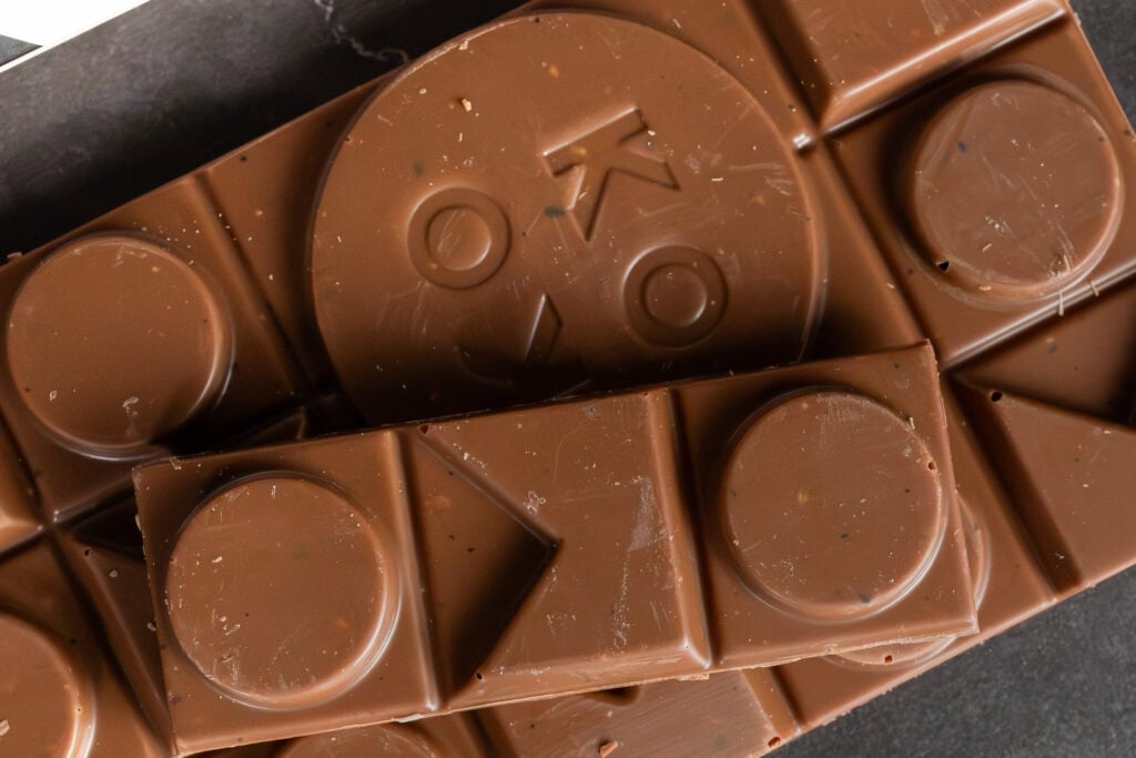 Close-up of Mighty Macadamia and Wattleseed chocolate showing embossed details and smooth texture