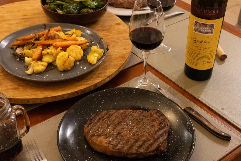 Yalumba The Signature Cabernet Sauvignon Shiraz 2021 served with wagyu steak and roasted vegetables