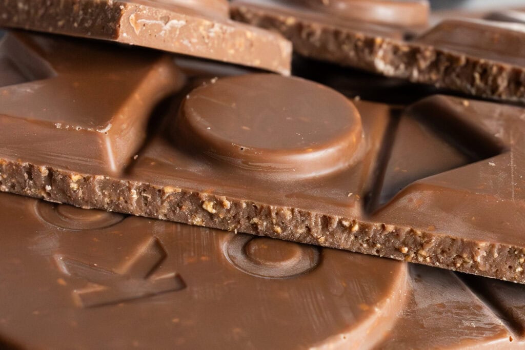 Close-up of Koko Black Caramelised Coconut chocolate showing smooth milk chocolate and toasted coconut texture