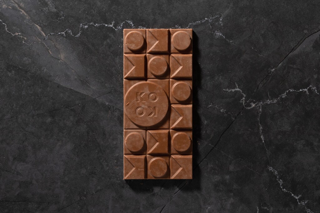 Top view of Koko Black Caramelised Coconut milk chocolate bar with segmented squares