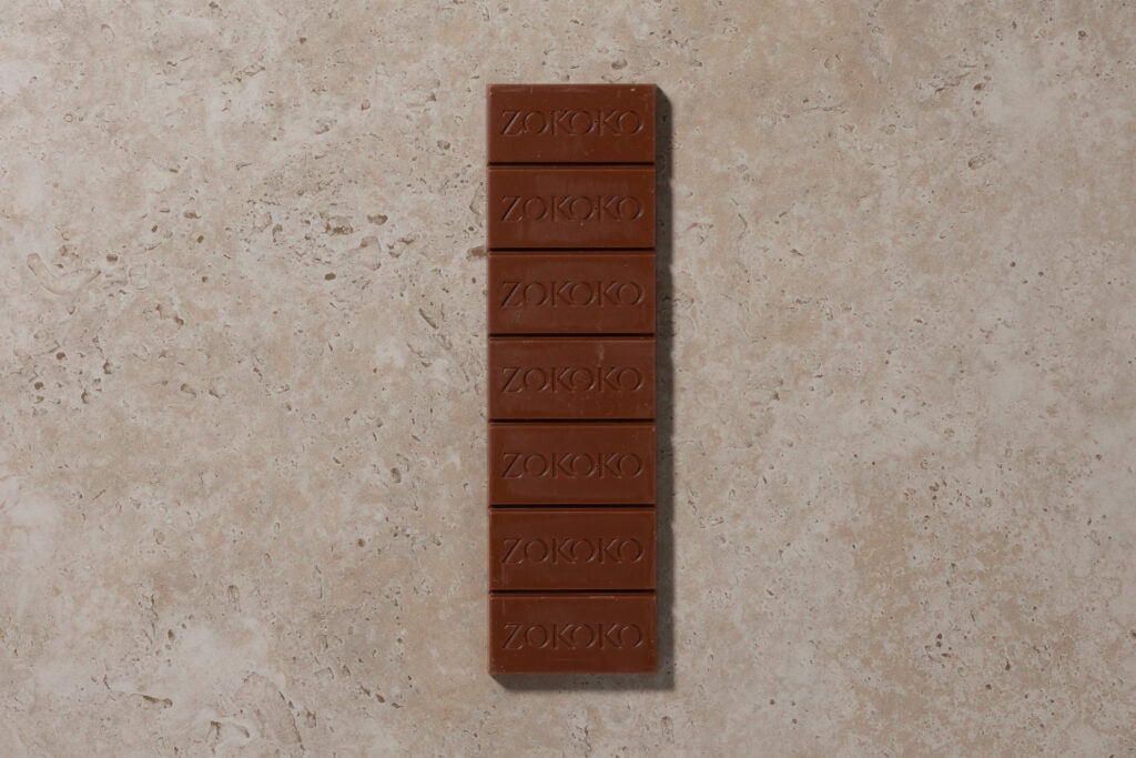 Zokoko Chale Milk 45% chocolate bar with segmented blocks on cream coloured stone