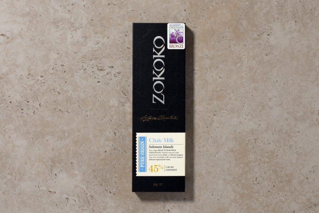 Zokoko Chale Milk chocolate from the Solomon Islands in matte black packaging on cream colour stone