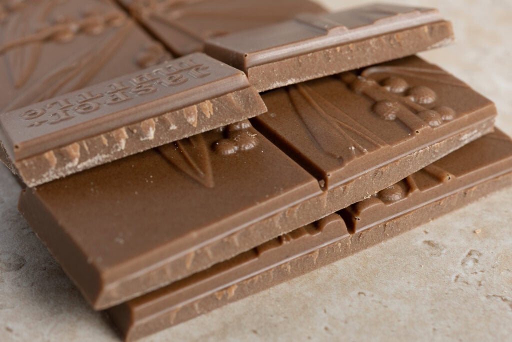 Close-up of Jasper + Myrtle Caffè Bianco white chocolate squares showing texture and interior