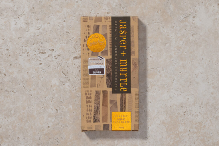 Jasper + Myrtle Classic Milk Chocolate 46% bar in packaging on stone background