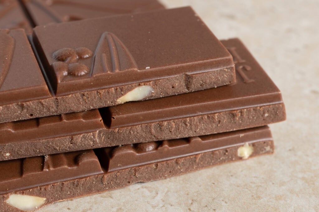 Close-up of Jasper + Myrtle 45% milk chocolate showing macadamia pieces inside the bar