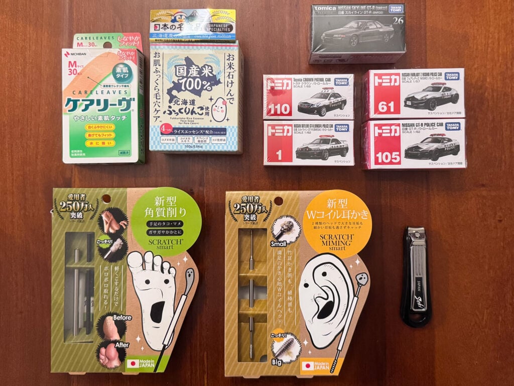 Items purchased at MEGA Don Quijote Tokyo including Japanese grooming tools, bandages and Takara Tomy die-cast cars