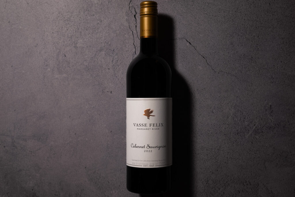 Bottle of Vasse Felix Margaret River Cabernet Sauvignon 2022 photographed against a textured concrete background.
