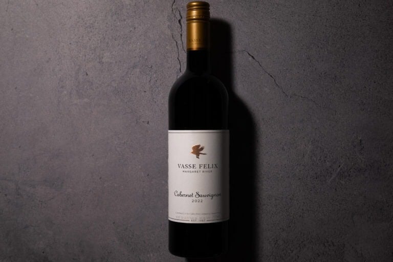 Bottle of Vasse Felix Margaret River Cabernet Sauvignon 2022 photographed against a textured concrete background.