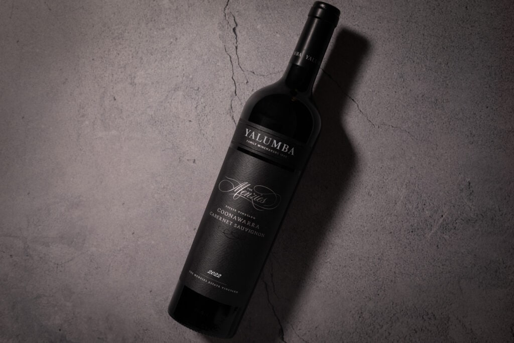 Yalumba The Menzies Coonawarra Cabernet Sauvignon 2022 bottle on textured stone surface