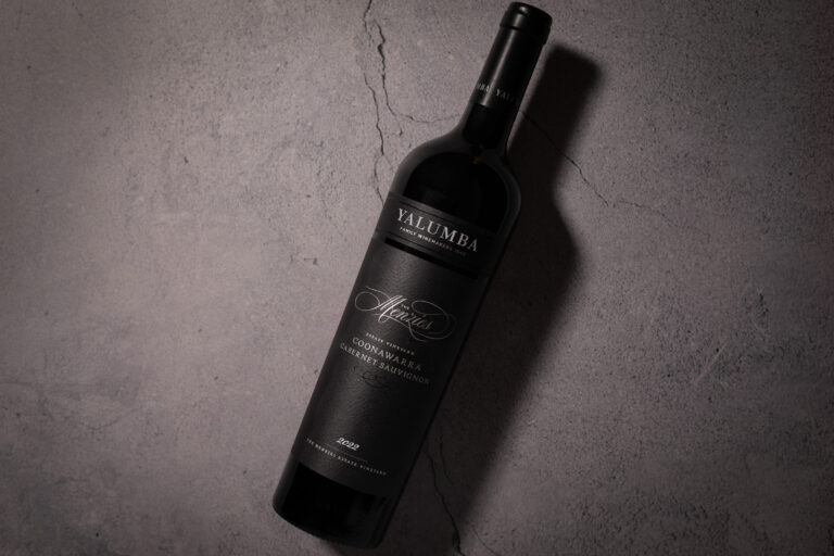 Yalumba The Menzies Coonawarra Cabernet Sauvignon 2022 bottle on textured stone surface
