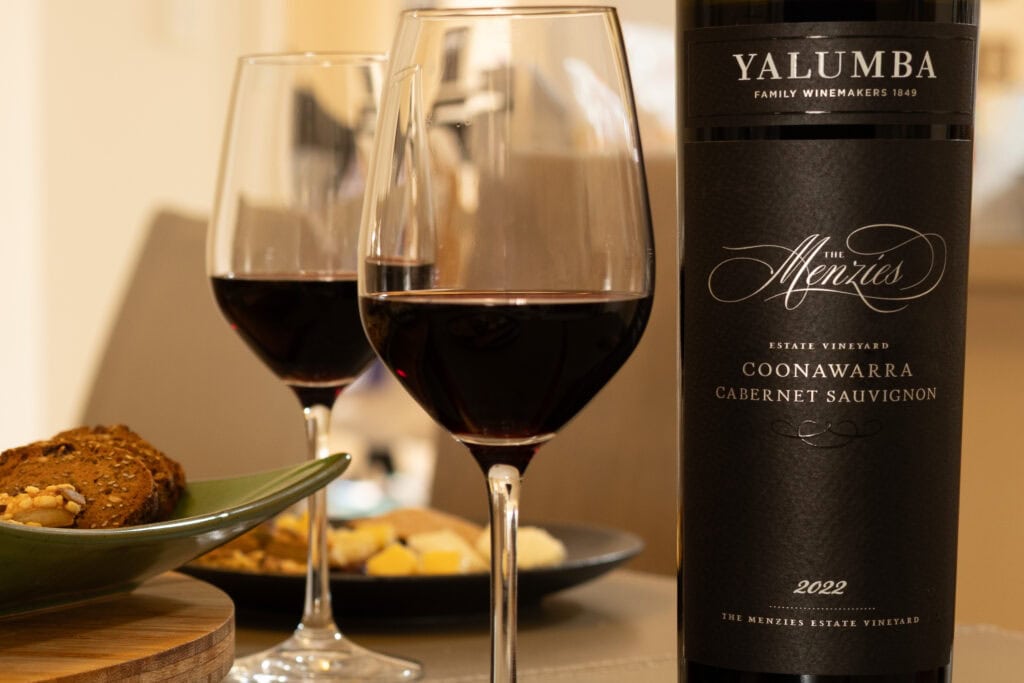 Glasses of Yalumba The Menzies Coonawarra Cabernet Sauvignon 2022 served with crackers and cheese