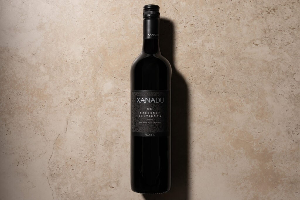 Xanadu Cabernet Sauvignon 2022 bottle on stone surface with soft shadow