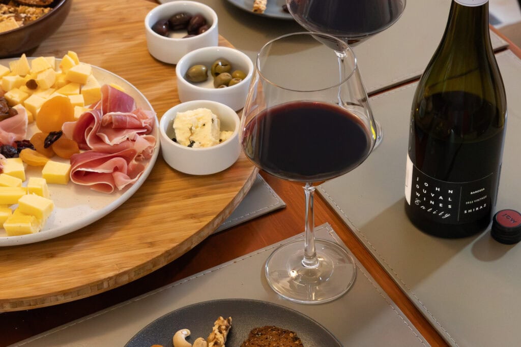John Duval Entity Shiraz 2022 served with cheese, prosciutto, olives, and Persian fetta