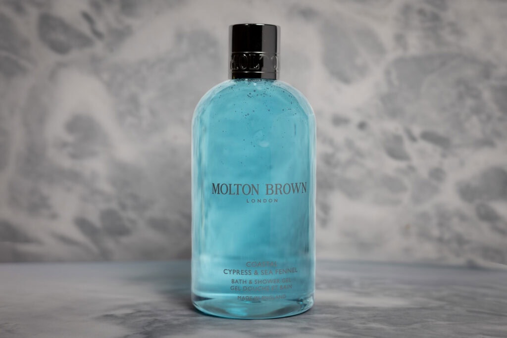 Molton Brown Coastal Cypress & Sea Fennel Bath & Shower Gel bottle on grey and white marble surface