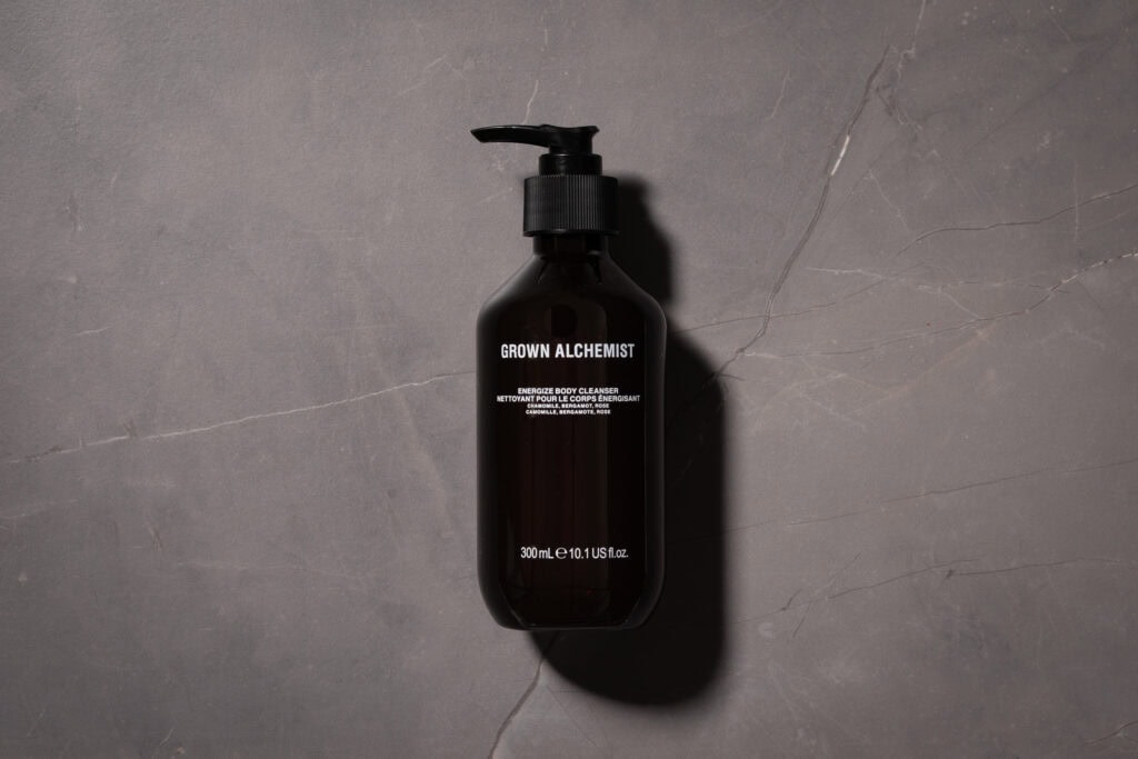 Grown Alchemist Energize Body Cleanser 300ml bottle on a grey stone surface