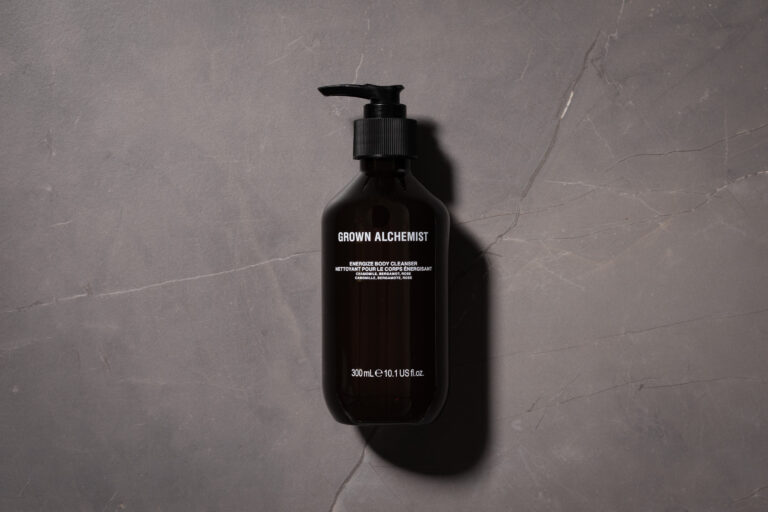Grown Alchemist Energize Body Cleanser 300ml bottle on a grey stone surface
