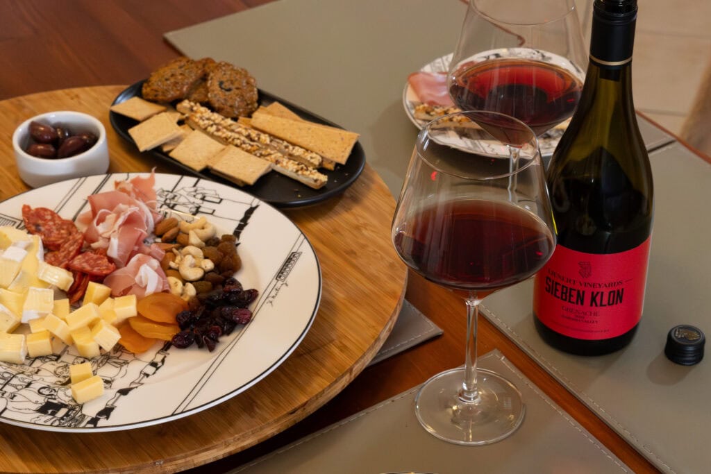 Lienert Vineyards Sieben Klon Grenache 2022 served with cheese, charcuterie, dried fruit and crackers