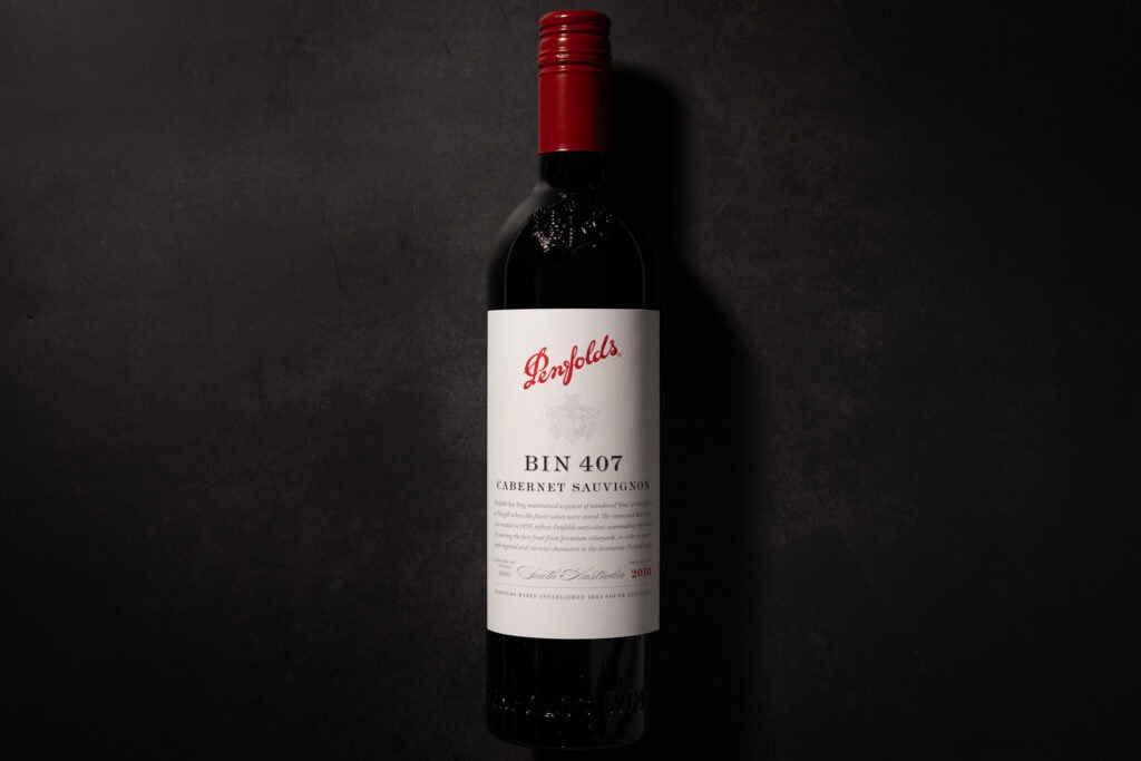 Penfolds Bin 407 Cabernet Sauvignon 2018 bottle on a dark stone background