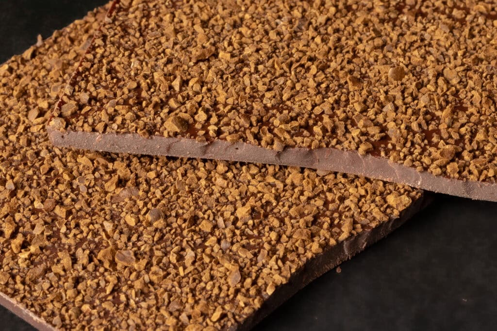 Close-up of Ratio Axil Coffee Dark Chocolate showing coffee pieces and chocolate thickness