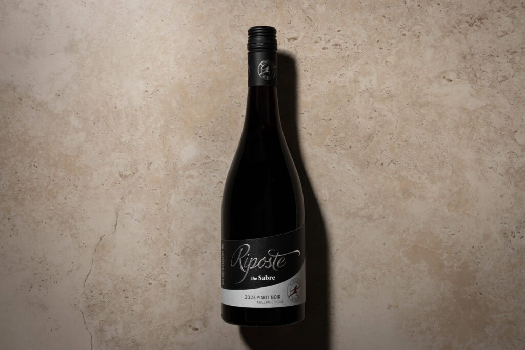 Riposte The Sabre Pinot Noir 2023 bottle from Adelaide Hills on a travertine background.