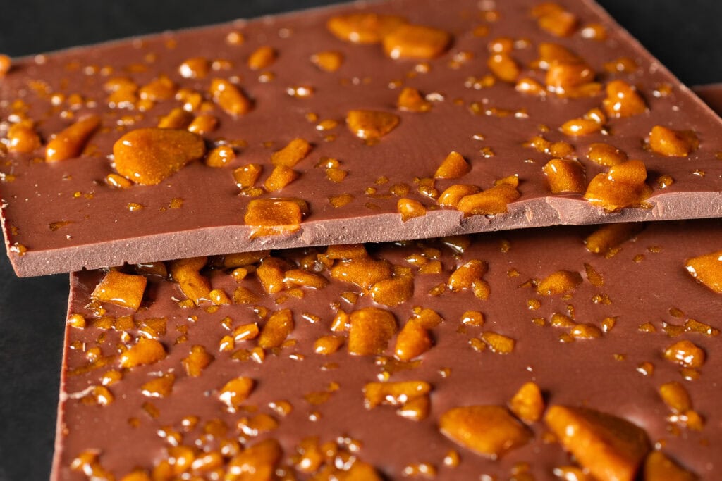 Close-up of Ratio Cocoa Roasters Salted Caramel Milk Chocolate with crisp caramel pieces