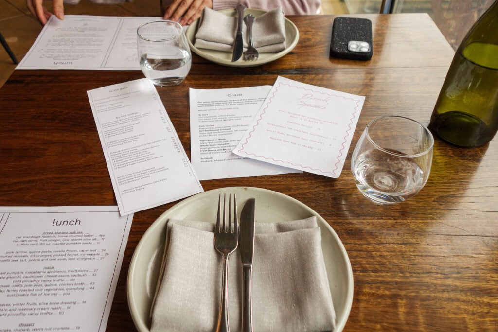 Table setting with lunch menus at Topiary Restaurant in Adelaide, South Australia.