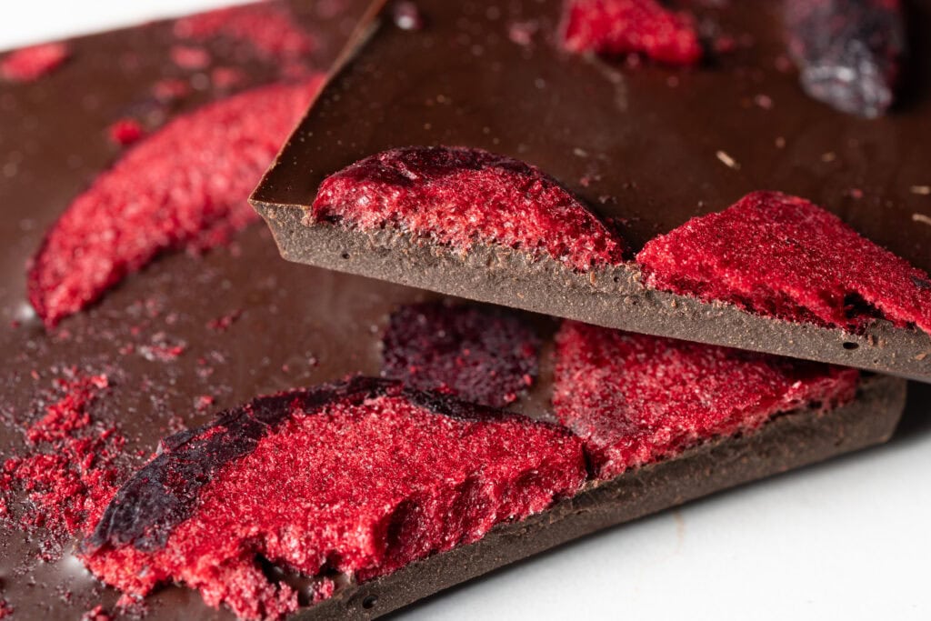 Close-up of Monsieur Truffe dark chocolate topped with red native plum pieces