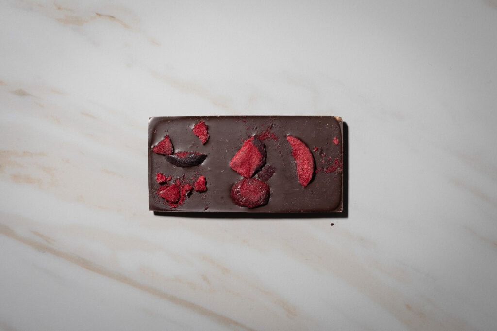 Monsieur Truffe 70% dark chocolate bar topped with pieces of native plum