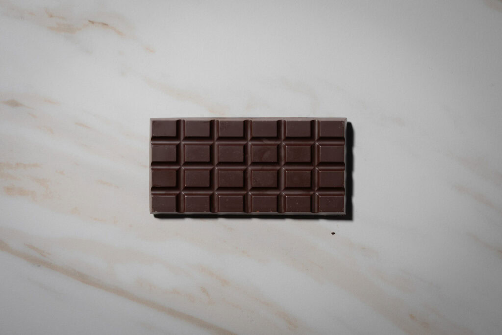 Back of the Monsieur Truffe Native Plums 70% dark chocolate bar showing the moulded blocks