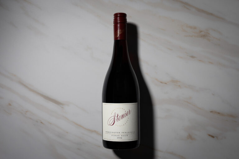 Bottle of Stonier Mornington Peninsula Pinot Noir 2024 standing on a light marble surface.