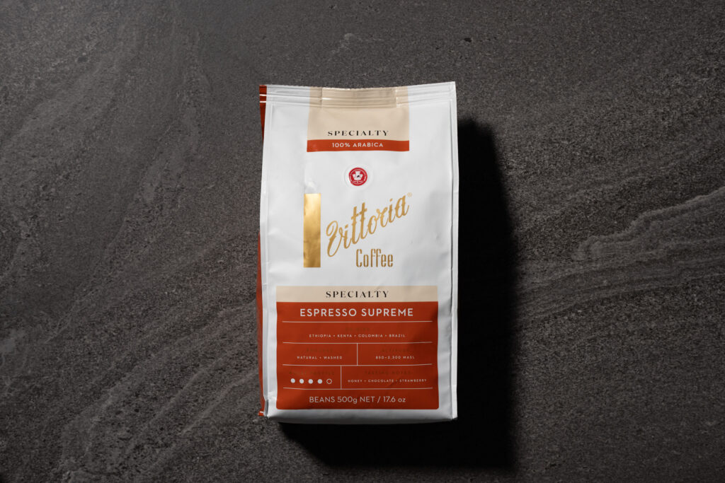 Bag of Vittoria Espresso Supreme Specialty Coffee Beans on a dark stone surface